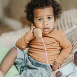 Child playing with the Grimm's wooden toy telephone. 