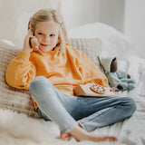 Child playing with the Grimm's wooden toy telephone. 