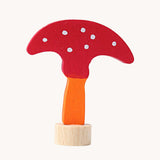 Grimm's decorative toadstool figure for celebration ring. A red coloured top with white dots and an orange coloured stalk.