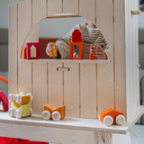 A child playing with wooden peg dolls and Grimm's windows. Grimm's wooden stacking car toys have been placed on a wooden shelf in front. These Grimm's toys are part of a wide range of wooden toys available here at Babipur. 