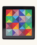 Grimms triangle magnet puzzle set. Includes 64 plywood triangular pieces in bright colours and a storage tin