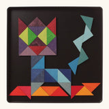A abstract cat using the Grimm's bright wooden triangular magnetic pieces displayed in a tin 