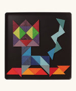 A abstract cat using the Grimm's bright wooden triangular magnetic pieces displayed in a tin 