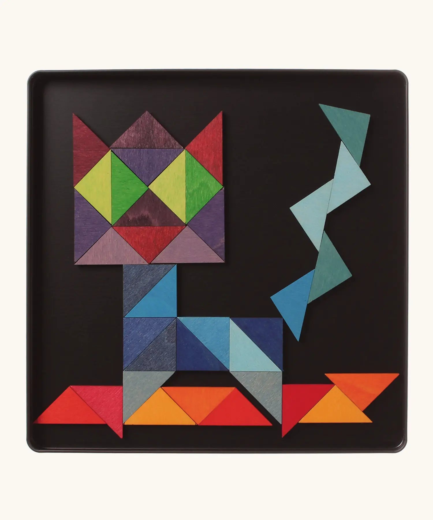 A abstract cat using the Grimm's bright wooden triangular magnetic pieces displayed in a tin 