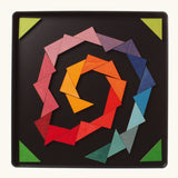 A abstract spiral shape using the Grimm's bright wooden triangular magnetic pieces displayed in a tin 