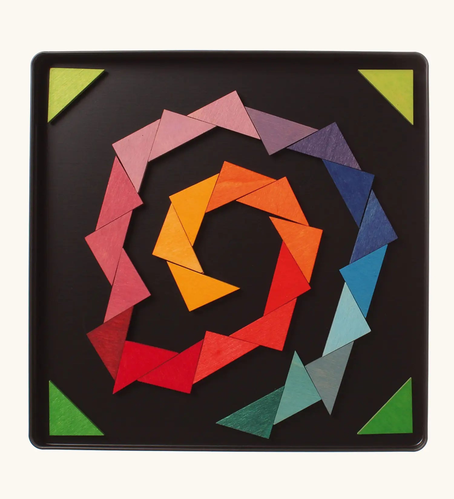 A abstract spiral shape using the Grimm's bright wooden triangular magnetic pieces displayed in a tin 