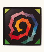 A abstract spiral shape using the Grimm's bright wooden triangular magnetic pieces displayed in a tin 