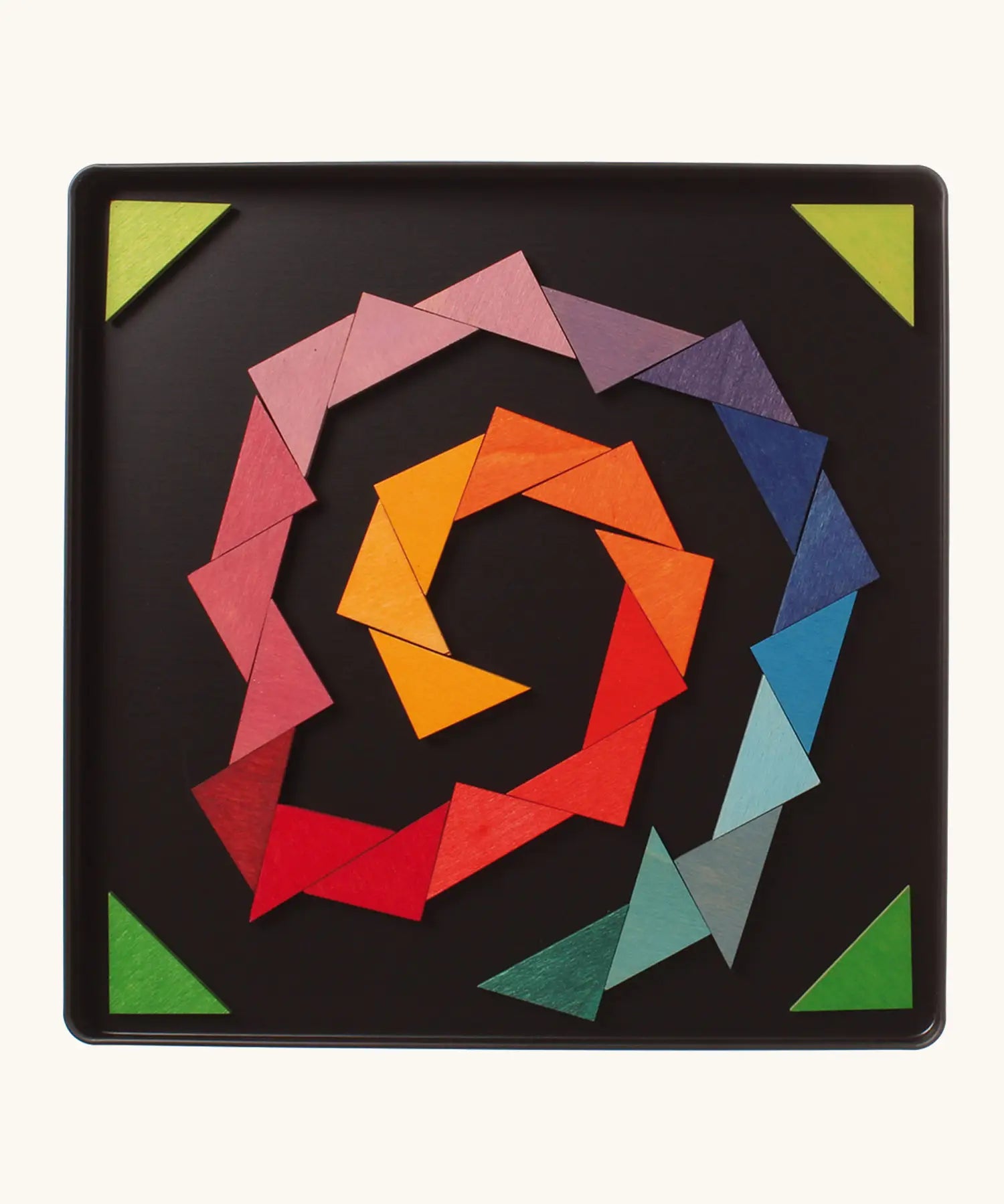 A abstract spiral shape using the Grimm's bright wooden triangular magnetic pieces displayed in a tin 