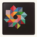 A abstract star shape using the Grimm's bright wooden triangular magnetic pieces displayed in a tin 