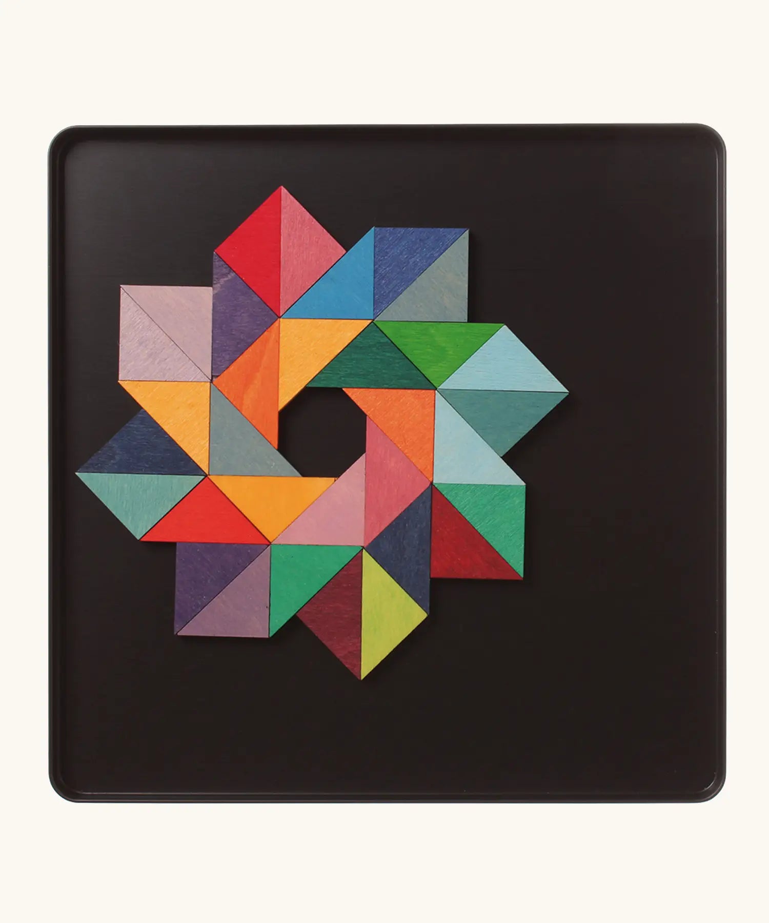 A abstract star shape using the Grimm's bright wooden triangular magnetic pieces displayed in a tin 