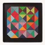 An open tin showing the Grimm's wooden magnetic triangular in bright colours