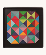 An open tin showing the Grimm's wooden magnetic triangular in bright colours
