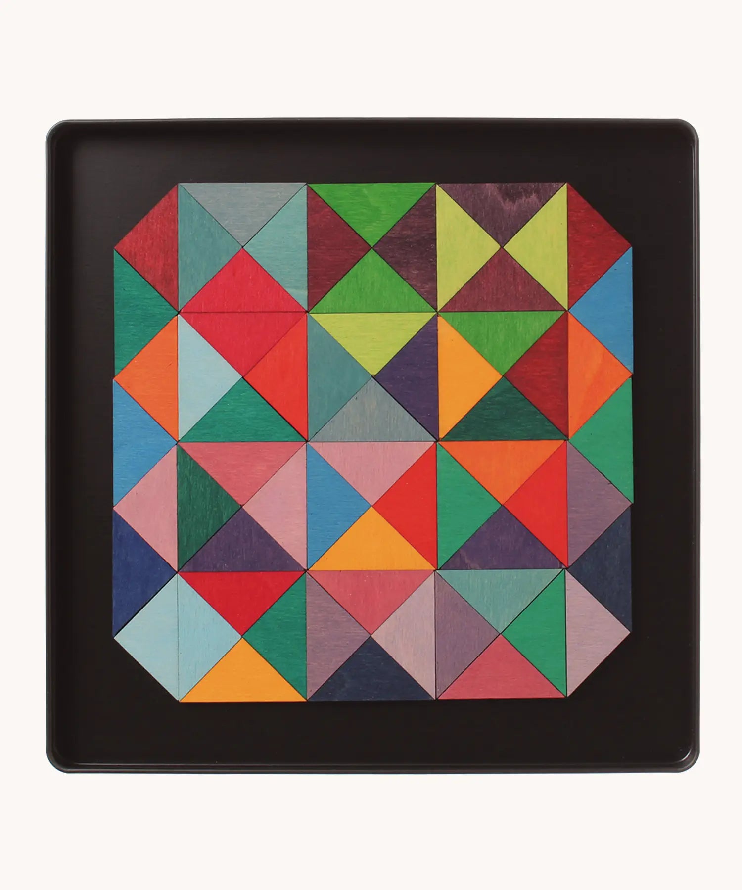 An open tin showing the Grimm's wooden magnetic triangular in bright colours