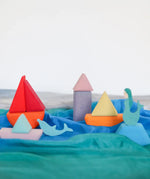 A ocean play scene made from the Grimm's handcrafted wooden triangle, square and circle pieces
