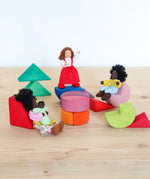 Grimms triangle, square and circle wooden blocks loose with waldorf dolls sitting on top