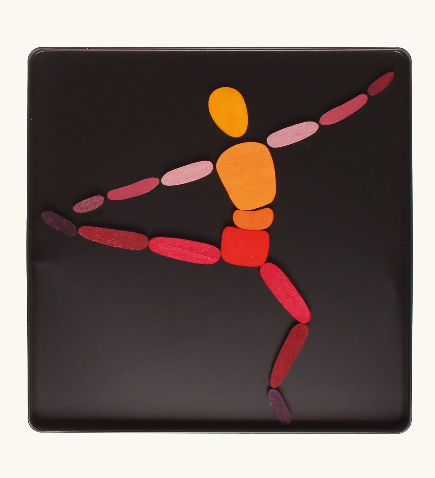 A ballet dancer made from the Grimm's bright wooden two bodies magnetic pieces displayed in a tin 