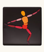 A ballet dancer made from the Grimm's bright wooden two bodies magnetic pieces displayed in a tin 