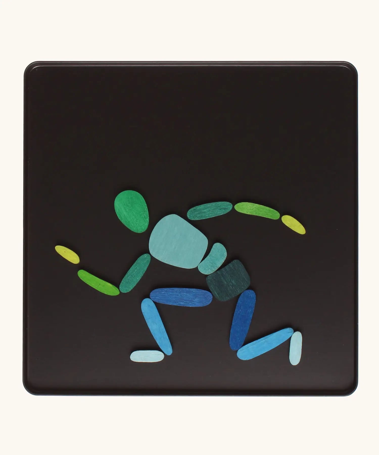 A person crouched made from the Grimm's bright wooden two bodies magnetic pieces displayed in a tin 
