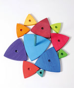 Overhead view of loose wooden triangular pieces and base from the Grimms wankel tower