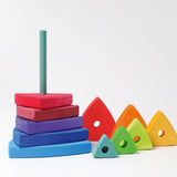 Loose wooden triangular pieces standing next to a base from the Grimms wankel tower set