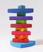 A Grimms wankel tower. Wooden triangluar pieces im Grimms world of numbers palette threaded through a pole on a base