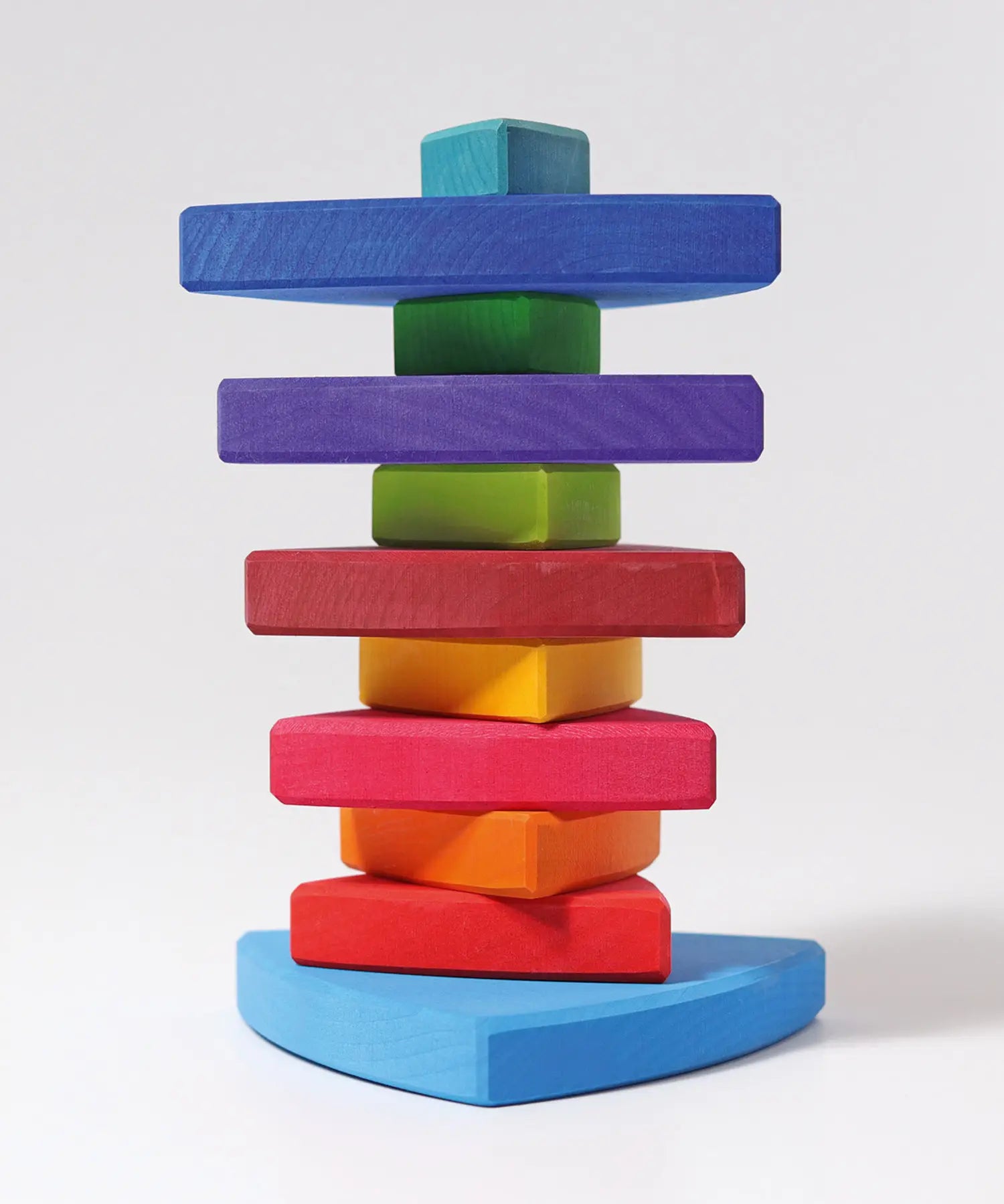 A Grimms wankel tower. Wooden triangluar pieces im Grimms world of numbers palette threaded through a pole on a base