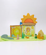 A sunny display showing a Grimms weather book, wooden weather blocks and other yellow and orange coloured blocks