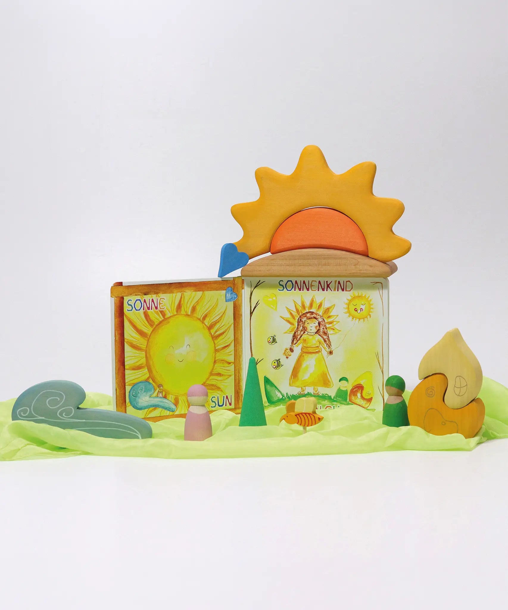 A sunny display showing a Grimms weather book, wooden weather blocks and other yellow and orange coloured blocks