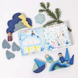 A winter display showing a Grimms weather book, wooden weather blocks and other blue coloured blocks