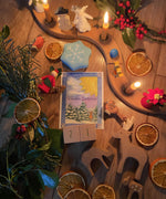 A top down photo of a beautiful Winter Solstice display using the Grimms wooden celebration ring, various Winter Grimms decorative figures, Grimms candles and other wooden figures available at Babipur.