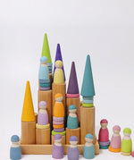 Grimm's large wooden building rollers in natural in a tray with pastel friends and forest pieces placed on top of them.