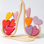 Grimm's Building Set Red Hearts shown with the hearts balanced on the frame pieces. 