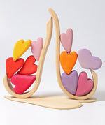 Grimm's Building Set Red Hearts shown with the hearts balanced on the frame pieces. 
