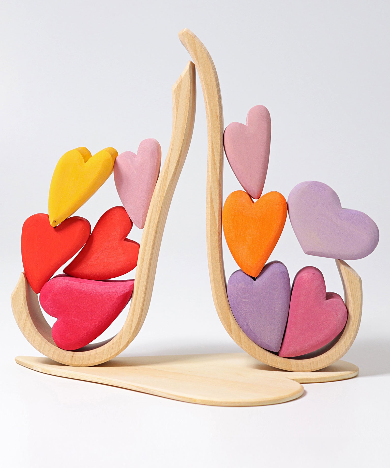 Grimm's Building Set Red Hearts shown with the hearts balanced on the frame pieces. 