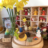 A bright and cheerful inspired calendar display using a Grimm's 12 hole Waldorf Celebration Ring, Grimm's decorative figures and a Ambrosius doll available at Babipur.