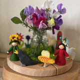 A beautiful display using a Grimm's Waldorf Celebration Ring , various Grimm's decorative figures available at Babipur. Display has a bunch of flowers in the middle