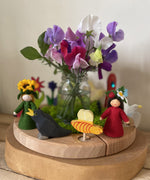 A beautiful display using a Grimm's Waldorf Celebration Ring , various Grimm's decorative figures available at Babipur. Display has a bunch of flowers in the middle