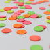 A close up of the Grimms wooden confetti dots. Showing the hand painted neon finish 