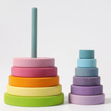 Grimms large wooden conical tower in pastel colours showing bottom half on the base and upper half loosely stacked 