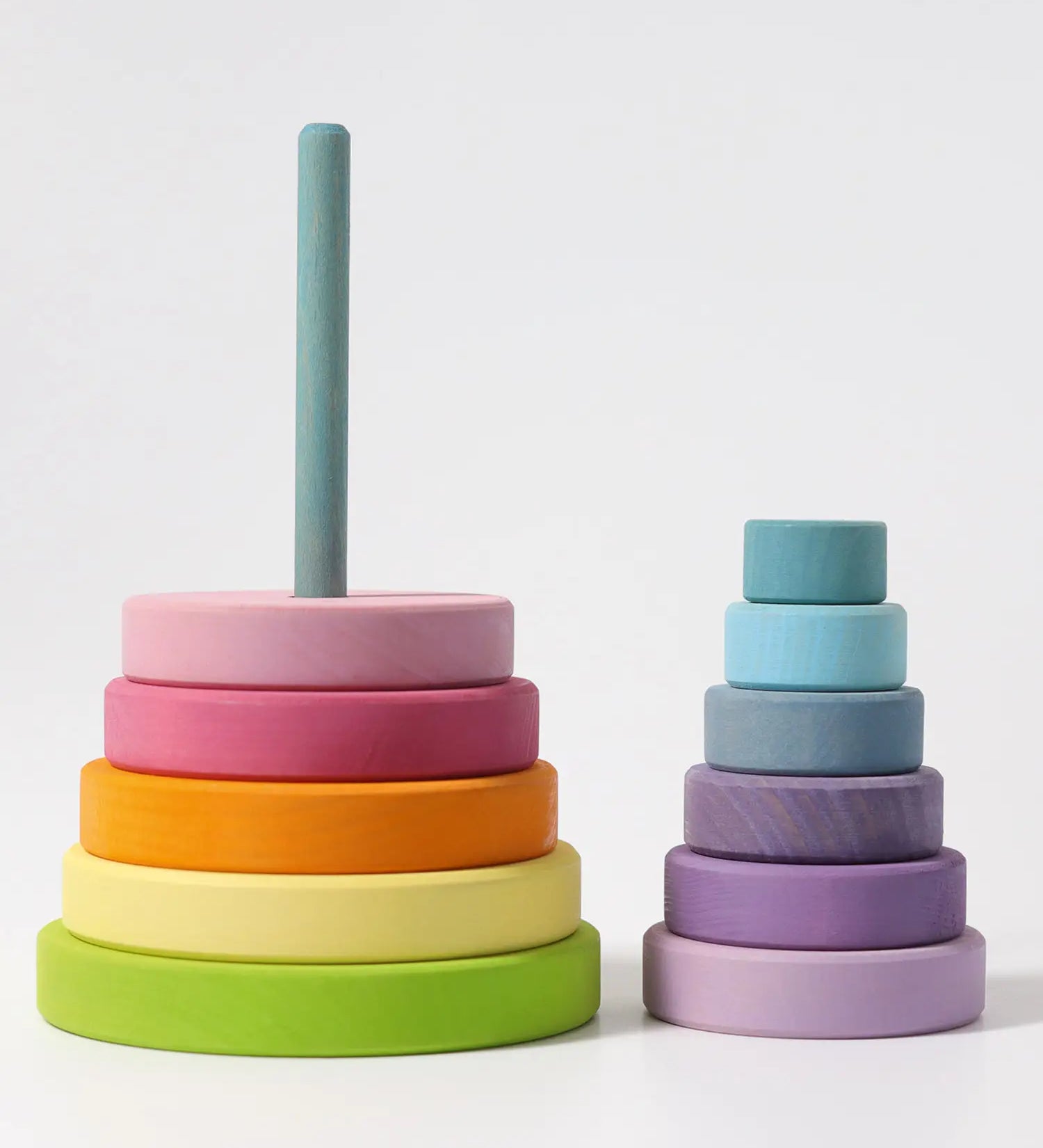 Grimms large wooden conical tower in pastel colours showing bottom half on the base and upper half loosely stacked 