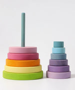 Grimms large wooden conical tower in pastel colours showing bottom half on the base and upper half loosely stacked 
