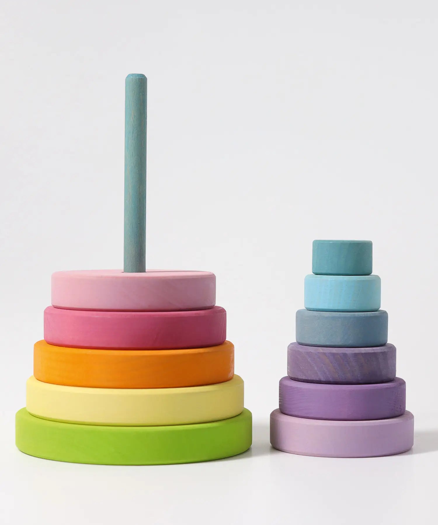 Grimms large wooden conical tower in pastel colours showing bottom half on the base and upper half loosely stacked 
