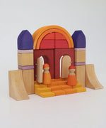 A simple house structure made from wooden blocks from the Grimms desert sand set