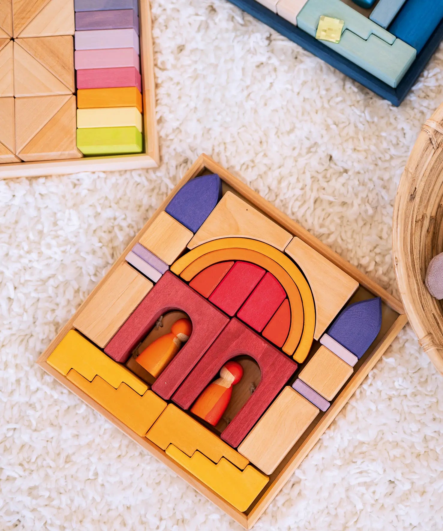 Overhead view of a Grimms wooden desert sand set on a fluffy rug