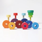 Grimms fabuto stacking set in a rainbow palette showing loose disk pieces with a hole in the middle 