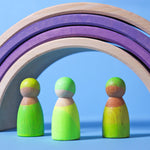Grimm's Friends - Neon Green - On a plain blue background. A Grimm's Neon Pink Stacking Tower is in the background.