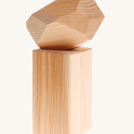Grimm's Natural Wooden Gem on a plain background. 