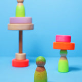 Grimms handcrafted wooden neon green peg doll showing a close up of the grain detail 