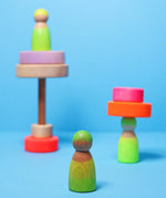 Grimms handcrafted wooden neon green peg doll showing a close up of the grain detail 
