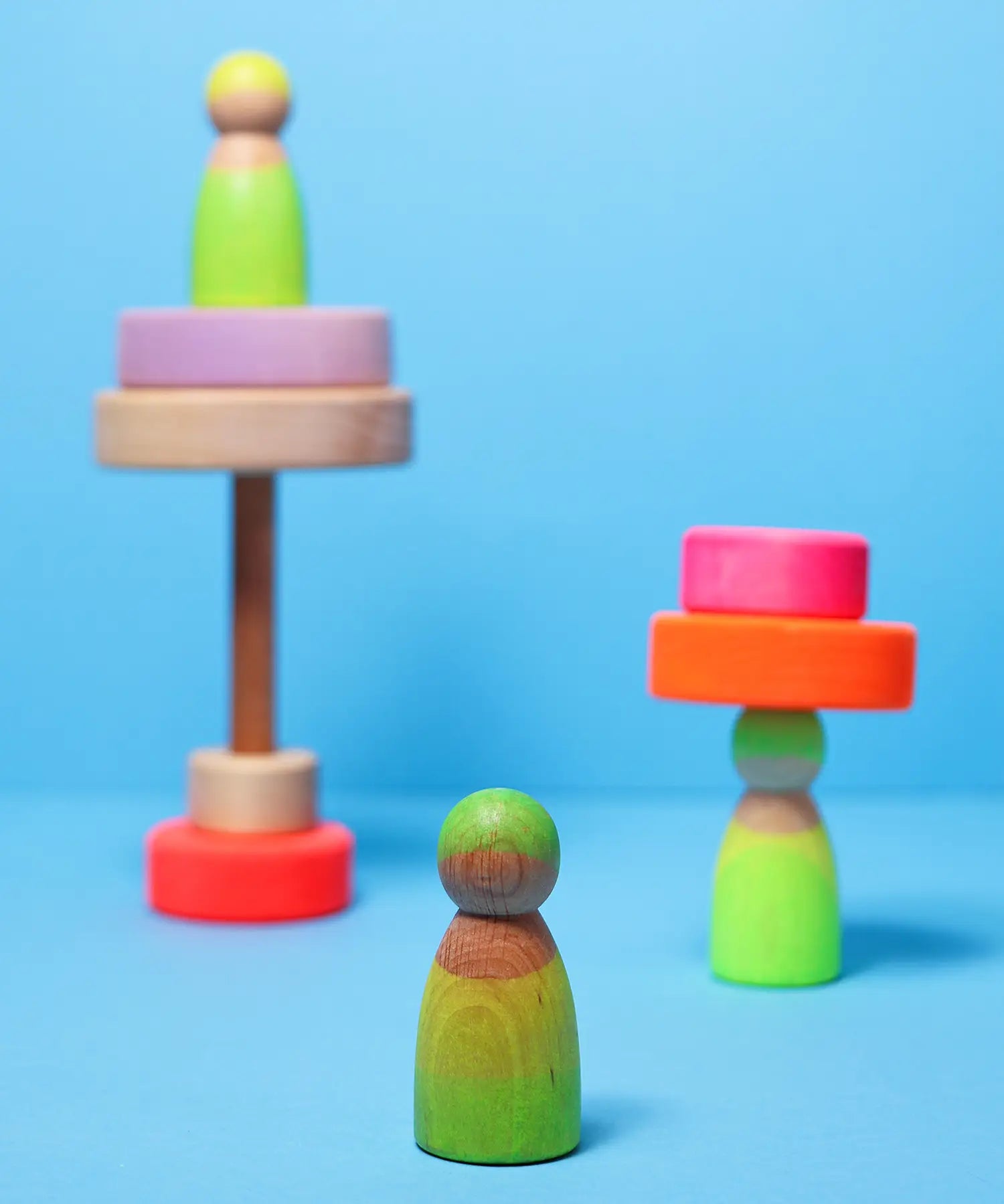 Grimms handcrafted wooden neon green peg doll showing a close up of the grain detail 